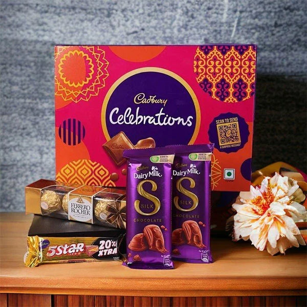 Assorted chocolate gift box with Cadbury Celebrations, Dairy Milk Silk, Ferrero Rocher, 5 Star, and a flower arrangement, ideal for festive gifting.