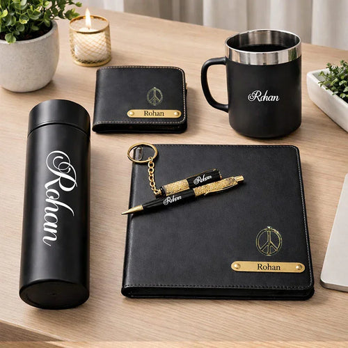 Personalized stationery items including a mug, thermos, pen, keychain, and notebook on a wooden surface.