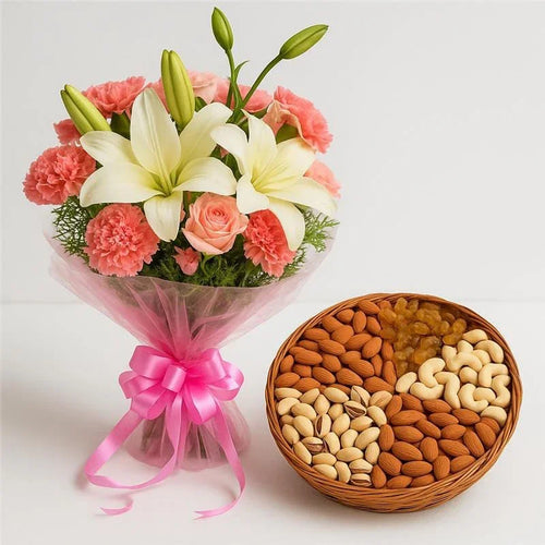 Bouquet of pink flowers with lilies and a basket of assorted dry fruits 