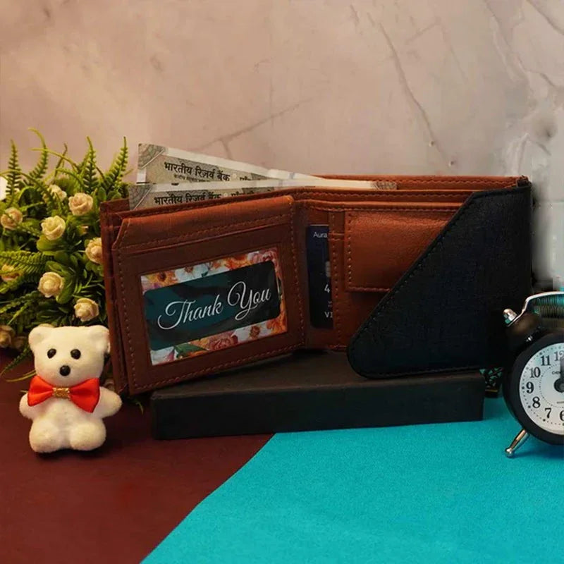 Brown leather wallet with 'Thank You' card, teddy bear, and clock on a textured surface