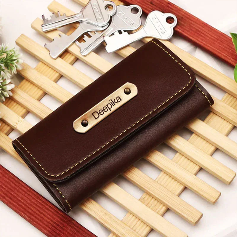 Brown leather wallet with 'Deepika' branding on a wooden surface