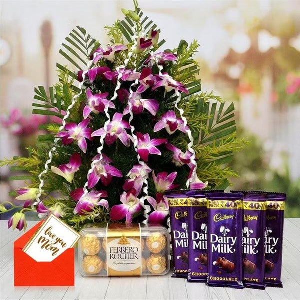 Floral arrangement with pink orchids and Cadbury Dairy Milk chocolate bars on a blurred background