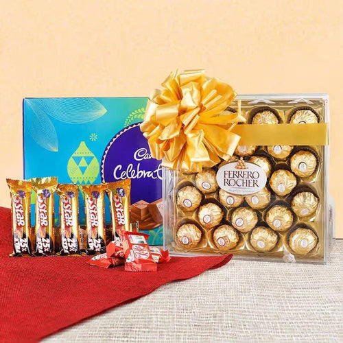 Ferrero Rocher chocolate set with a large yellow bow and Nestle Star bars on a red cloth.