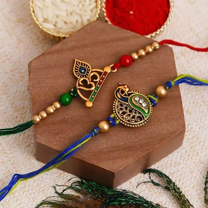 Decorative peacock-themed rakhi on a brown card with a textured beige background