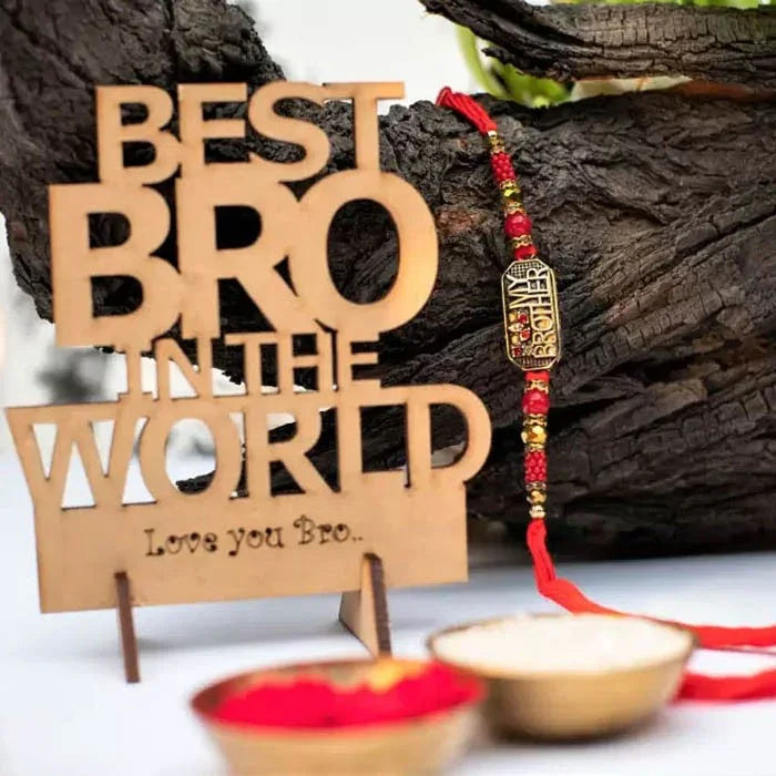 Wooden plaque with 'Best Bro in the World' text and a decorative rakhi on a wooden background.