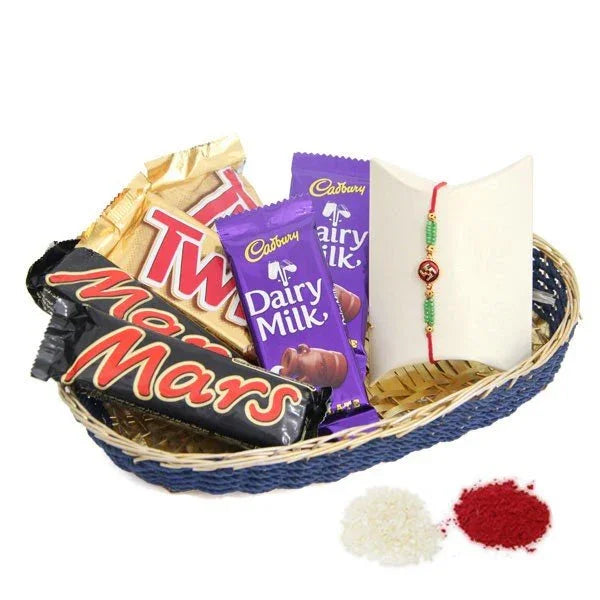 Rakhi gift hamper with assorted chocolates, rakhi bracelet, roli and chawal in a basket