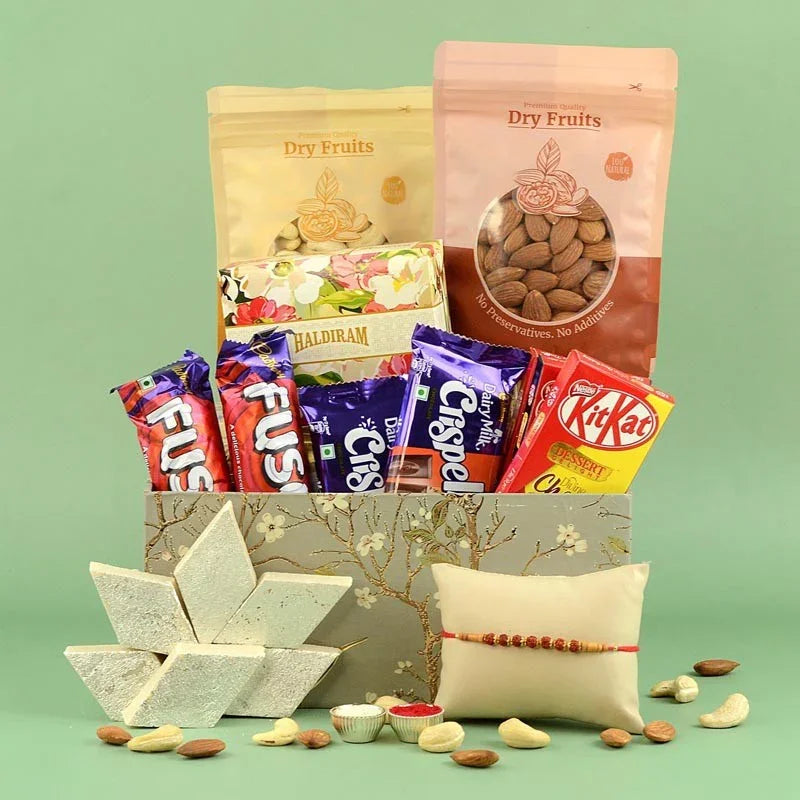 Assorted snacks and dry fruits in a decorative box on a green background