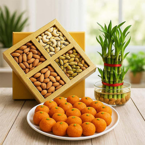 Assorted nuts in a wooden box, plate of Motichoor laddu, and bamboo plant 