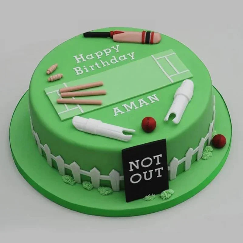 Green birthday cake with cricket-themed decorations and 'Happy Birthday Aman' text.