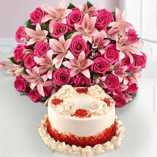 Bouquet of pink flowers with a red and white cake on a light background