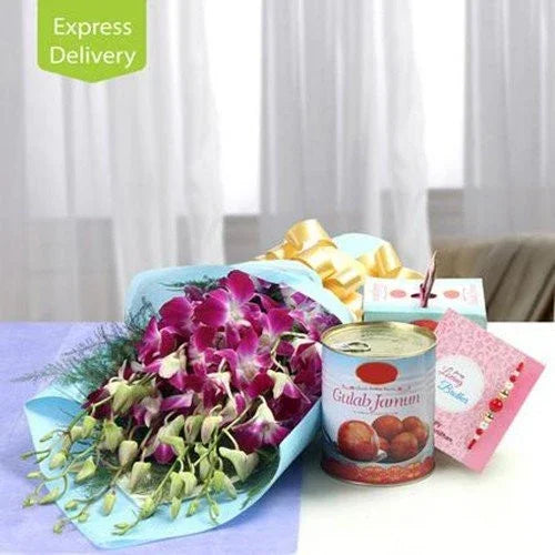 Gift combo with purple orchid bouquet, Gulab Jamun tin, greeting card, and Rakhi on table