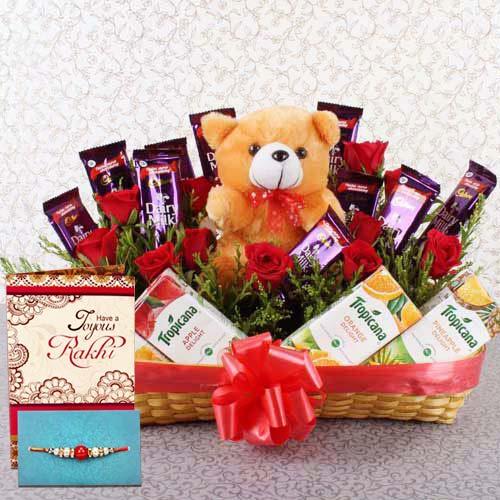 Gift basket with teddy bear, red roses, chocolates, Tropicana juices, Rakhi and greeting card