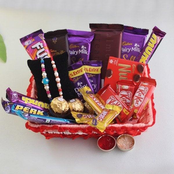 Gift basket with assorted chocolates, two rakhis, and roli chawal for Raksha Bandhan