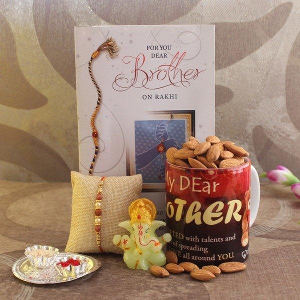 Rakhi gift set with greeting card, rakhi, mug of almonds, Ganesh idol, and roli chawal plate
