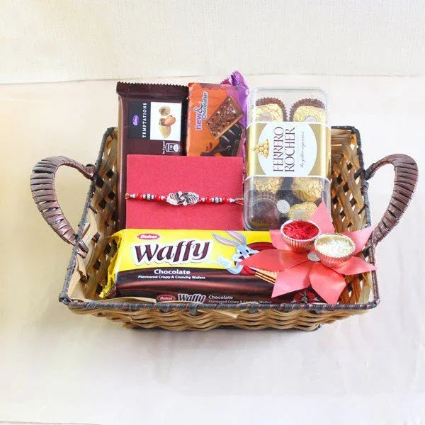 Gift basket with assorted chocolates and snacks Rakhi and roli chawal