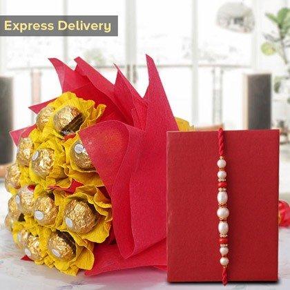 Bouquet of Ferrero Rocher chocolates wrapped in yellow paper with a red bow, next to a red card with a beaded Rakhi.