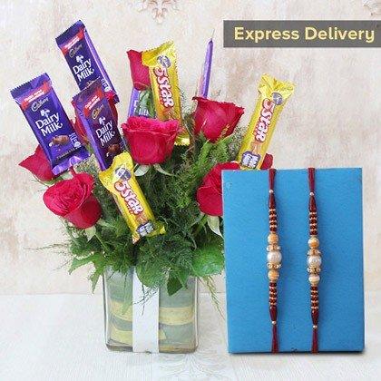 Bouquet of roses with Cadbury chocolate bars and two Rakhi ribbons 
