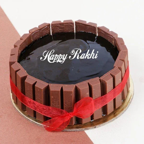 Chocolate KitKat cake with glossy topping, red ribbon, and 'Happy Rakhi' text for Raksha Bandhan