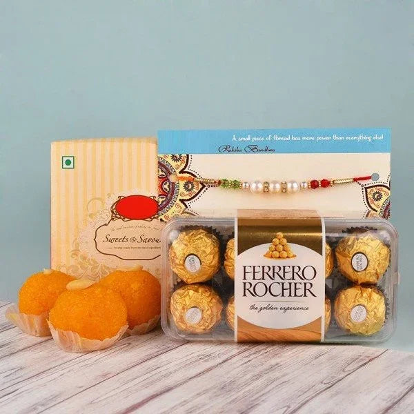 Raksha Bandhan gift set with rakhi, Ferrero Rocher chocolates, and Indian sweets on table
