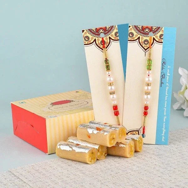 Rakhi gift set with two beaded rakhis and Indian sweets in a decorative box