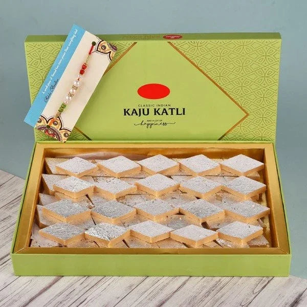 Open box of Kaju Katli sweets with decorative Rakhi, ideal for Raksha Bandhan gifting.