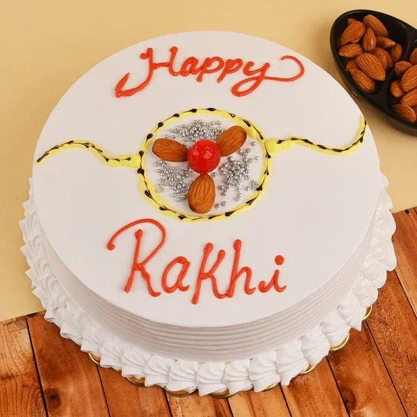 Happy Rakhi cake with white icing, almond and cherry decoration, festive celebration dessert