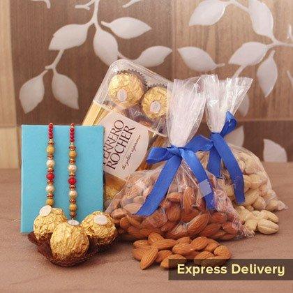 Gift hamper with Ferrero Rocher chocolates, dry fruits, rakhis, and express delivery label