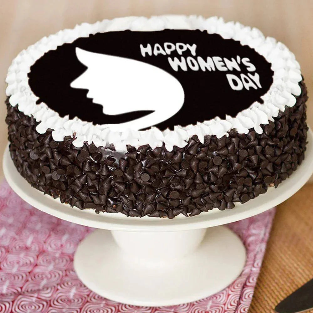 Chocolate cake with 'Happy Women's Day' text and silhouette on a white stand.