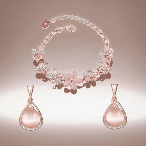 Pink floral necklace with matching earrings on a gradient background