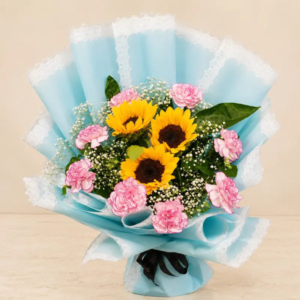 Yellow sunflower and pink carnation bouquet in aqua-blue lace wrapping