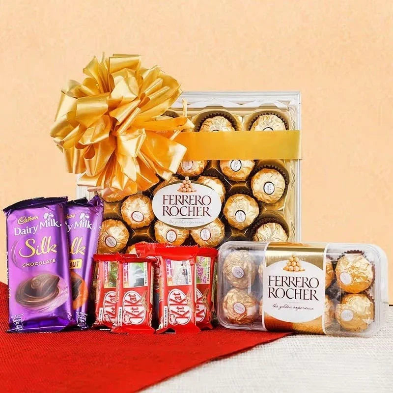 Assorted chocolate gift set with Ferrero Rocher, Cadbury Dairy Milk Silk, and Lindt chocolates on a red cloth with a beige background.