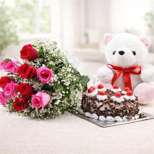 Bouquet of red and pink roses, chocolate cake with cherries, and a white teddy bear gift set