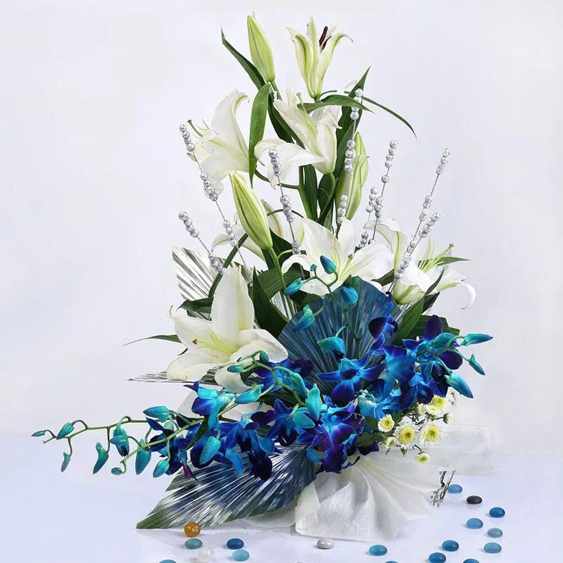 Bouquet of white lilies and blue orchids on a white background