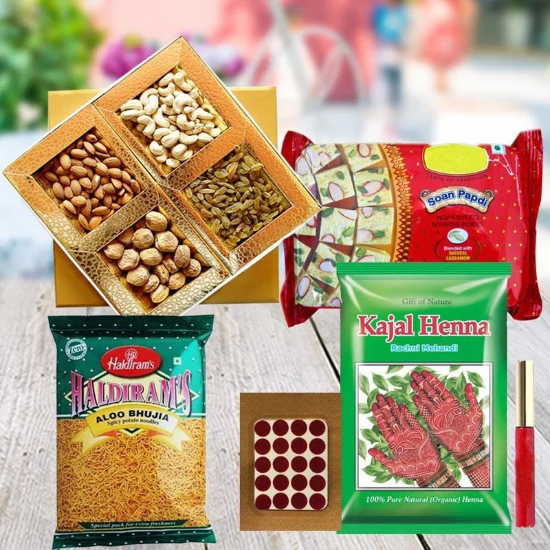 Assorted items including a box of nuts, packets of Haldiram's and Kajal Henna, and a box of Soan Papdi on a wooden surface.