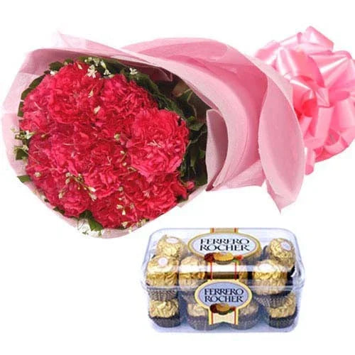Bouquet of red flowers with pink wrapping and a box of Ferrero Rocher chocolates on a white background