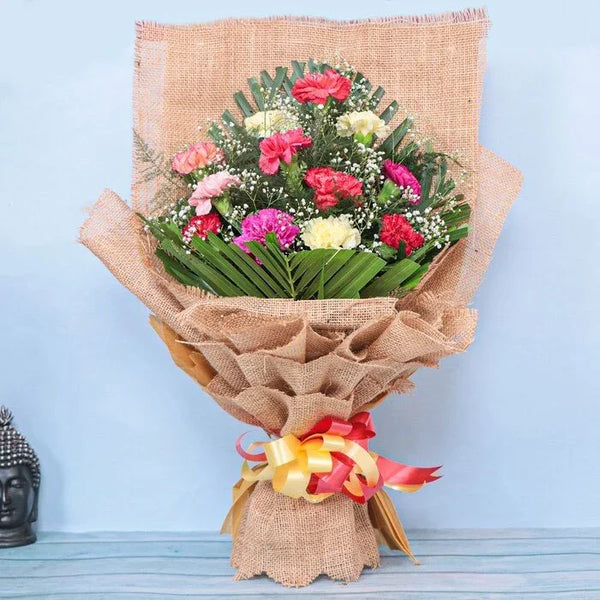 Colorful carnation bouquet wrapped in jute with decorative ribbon, ideal for gifting