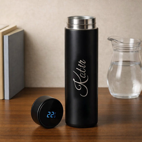 Black insulated bottle with digital temperature display on a wooden surface