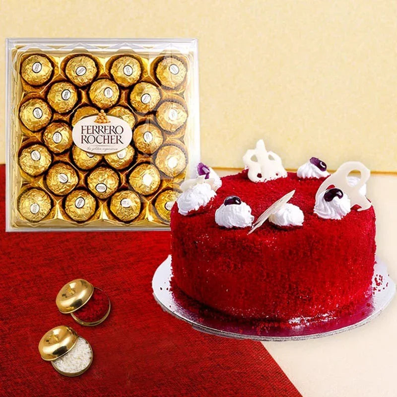 Red velvet cake with white decorations next to a box of Ferrero Rocher chocolates on a red surface.