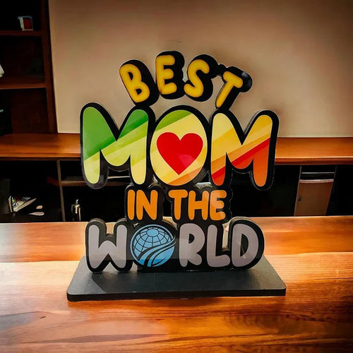 Decorative sign with 'Best Mom in the World' on a wooden surface