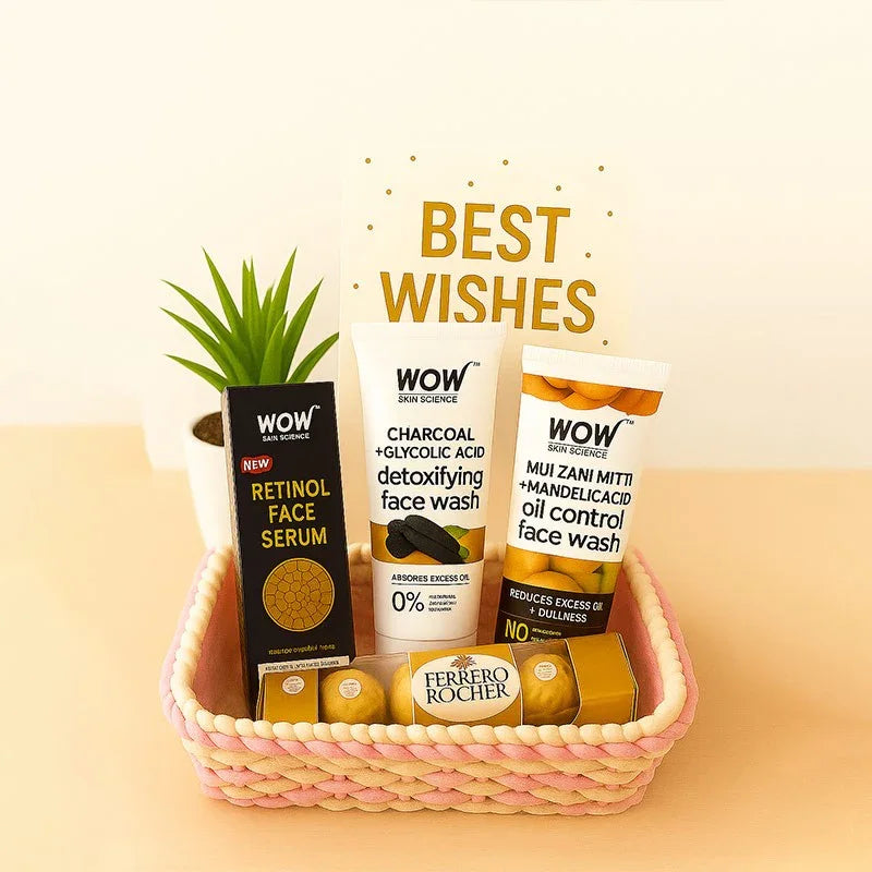 Basket of WOW Skin Science skincare products with a potted plant and Ferrero Rocher chocolates on a beige background, with 'BEST WISHES' text.