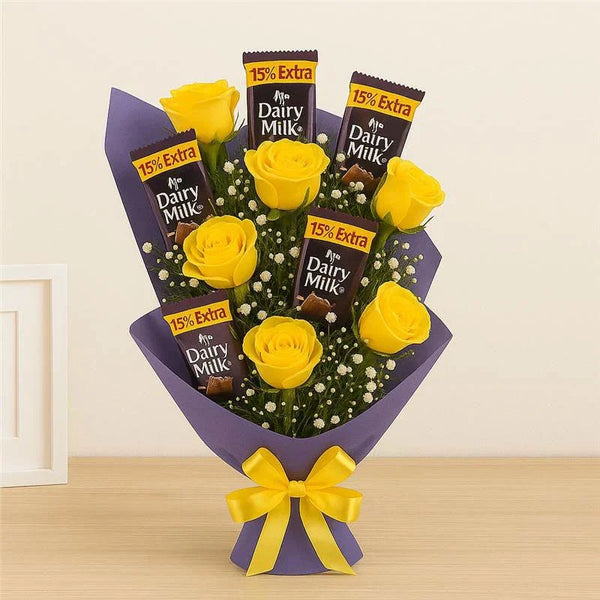Bouquet of yellow roses with dairy milk chocolate bars, gift wrapped with a yellow bow.