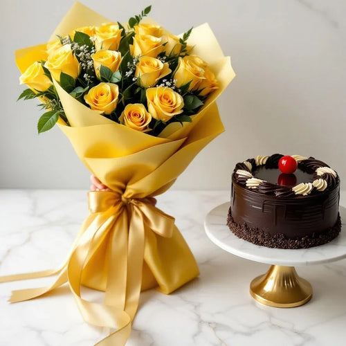 Bouquet of yellow roses wrapped in yellow paper with a chocolate cake on a marble surface.