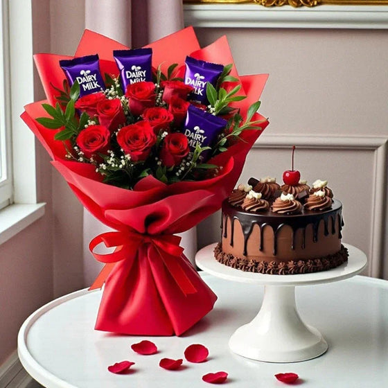 Bouquet of red roses with Dairy Milk chocolates and a chocolate cake with cherry on stand.