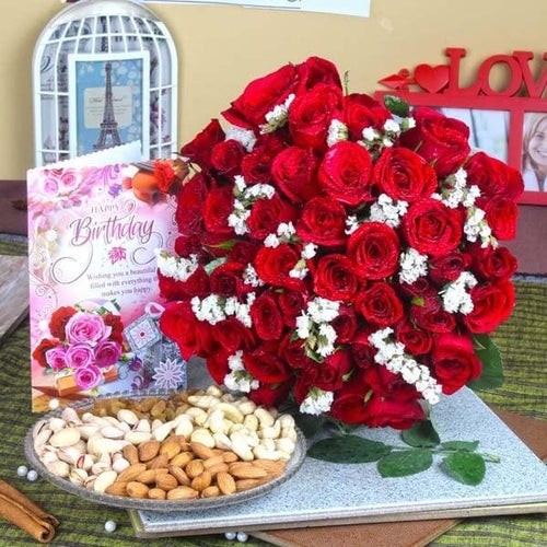 Red rose bouquet with white accents, birthday greeting card, and assorted dry fruits arranged 