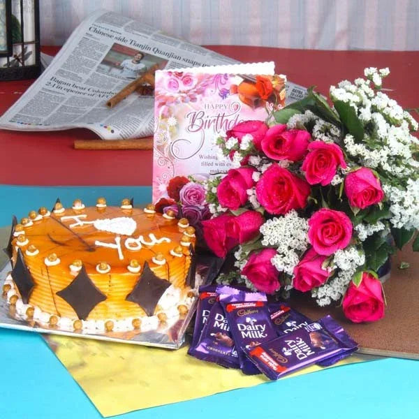 Birthday gift set with pink roses bouquet, caramel cake, chocolates, and a card