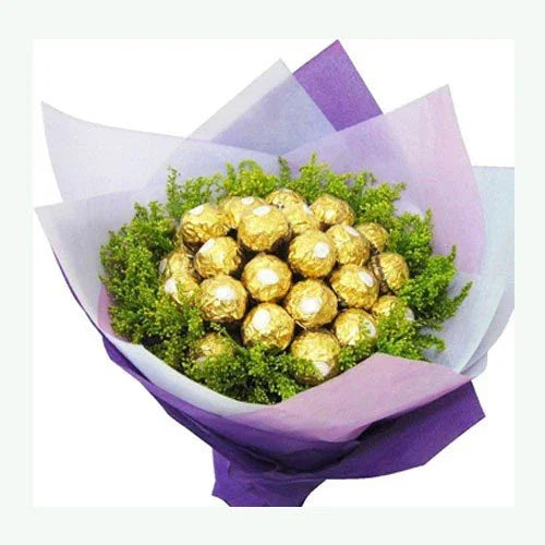 Bouquet of Ferrero Rocher chocolates wrapped in purple paper with green foliage