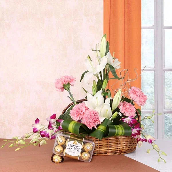 Basket Arrangement of White Asiatic Lilies, Pink Carnations with Ferrero Rocher 16 Pcs - Orchids Gift for Men