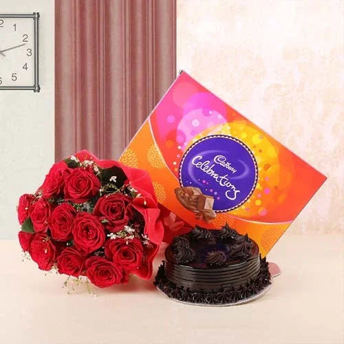 Red roses bouquet, chocolate cake, and Cadbury Celebrations gift box on a table