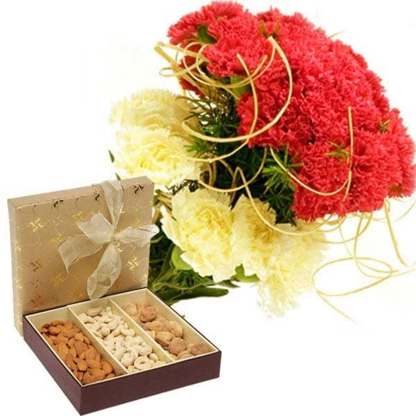 Bouquet of red and yellow carnations with a gift box of assorted dry fruits