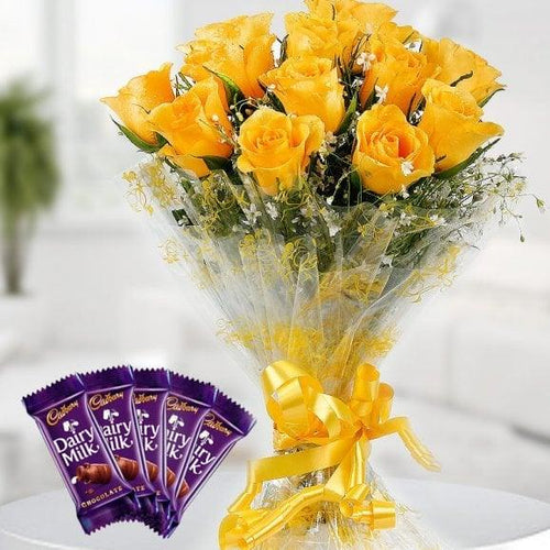 Bouquet of yellow roses with a Cadbury Dairy Milk chocolate bar